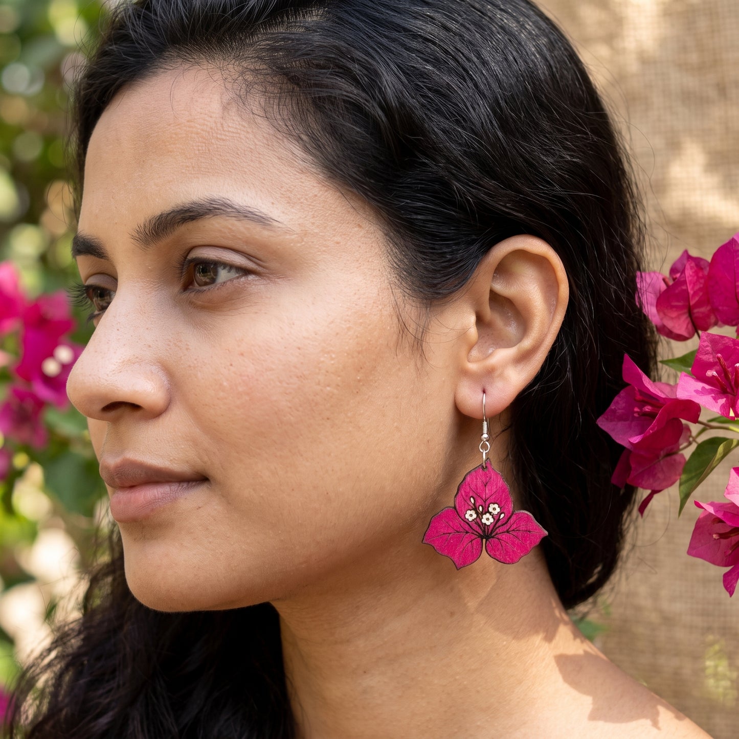 Woman wearing pink bougainvillea flower wooden dangle earrings, handmade jewelry by Mekala Crafts