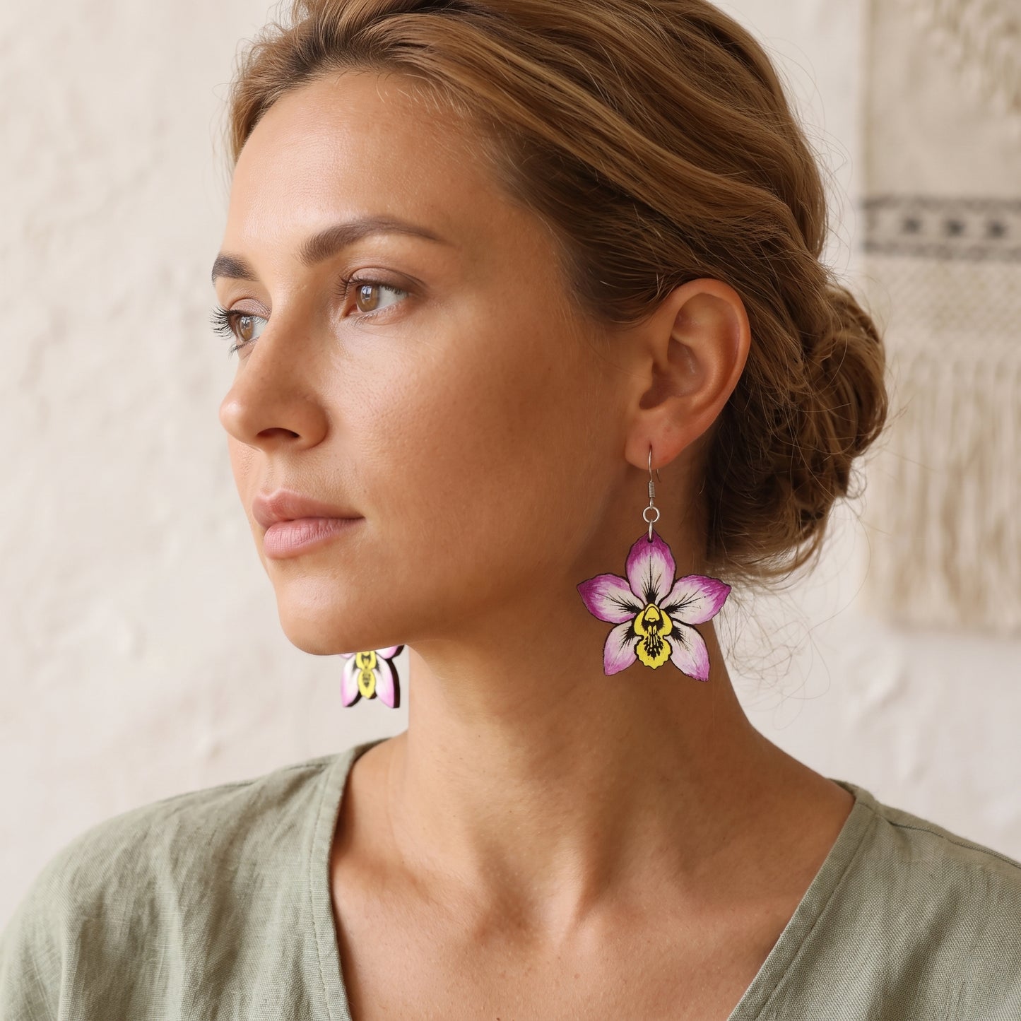 Woman wearing purple orchid flower wooden dangle earrings, handmade jewelry by Mekala Crafts