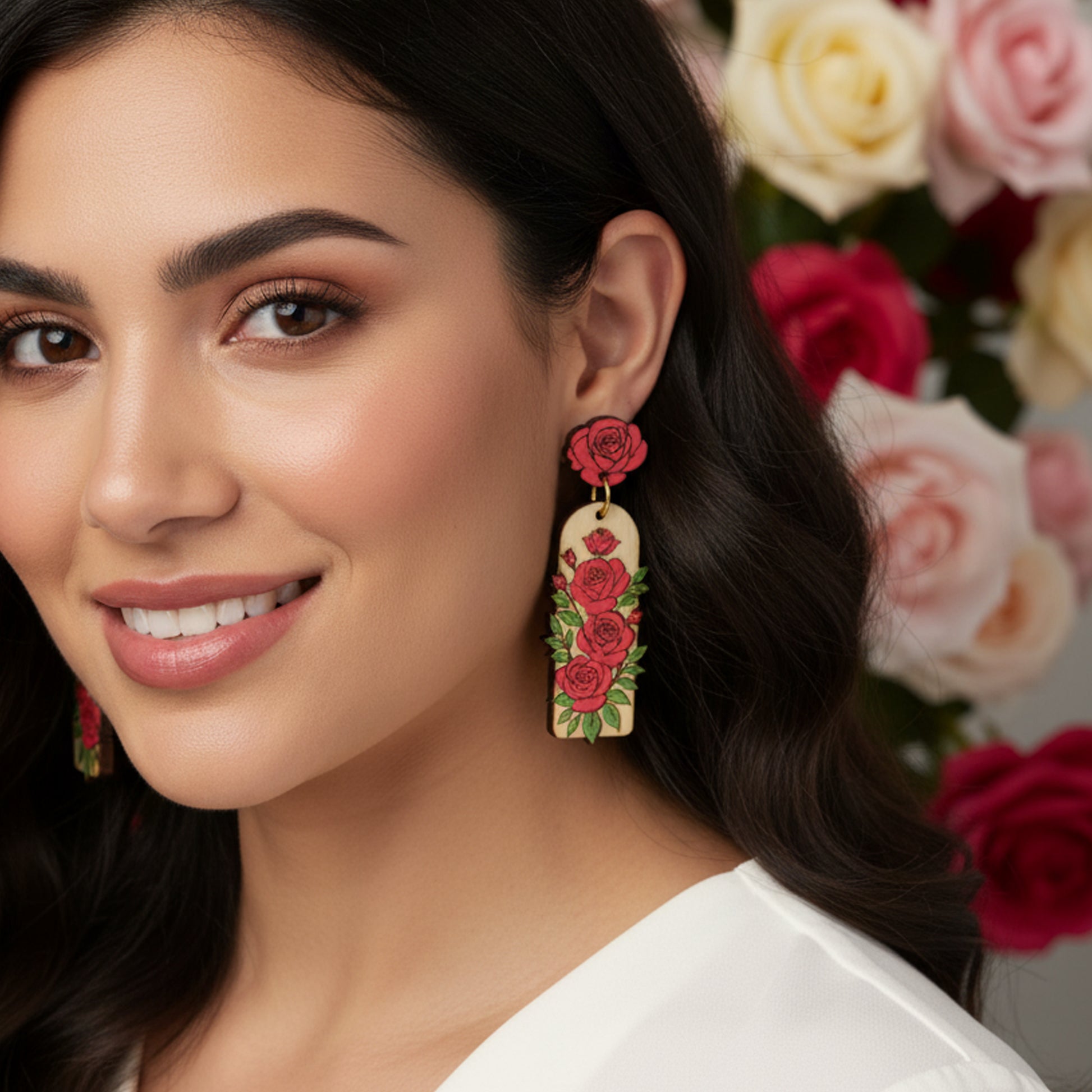 Woman wearing floral earrings with a background of roses