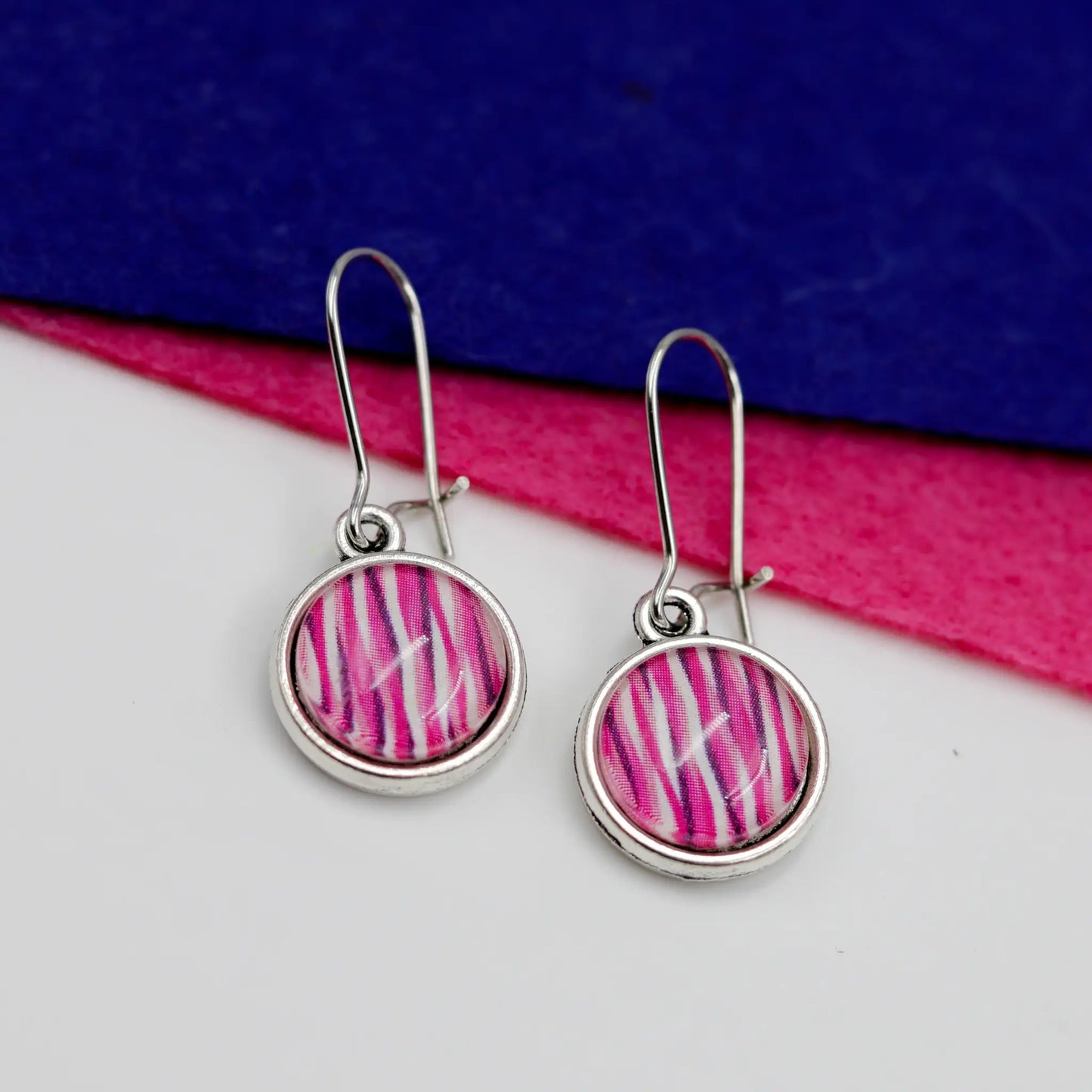 vibrant pink and purple wavy glass dome earrings
