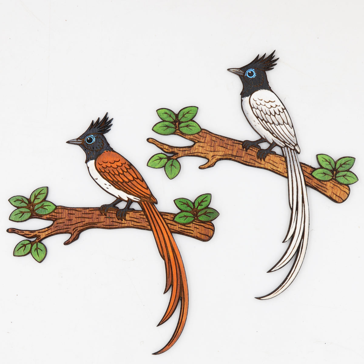 Hand-painted wooden bird magnets featuring Rufous Cinnamon and White Morph birds on leafy branches