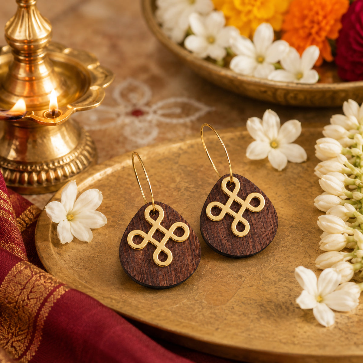 Teardrop-shaped wooden kolam knot earrings with gold hoops, festive Indian jewelry by Mekala Crafts