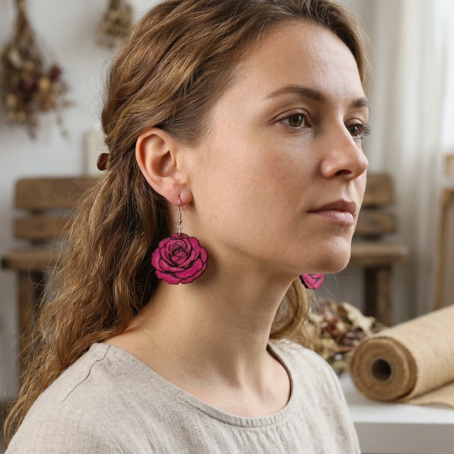 Woman wearing magenta pink rose flower wooden dangle earrings, handmade jewelry by Mekala Crafts
