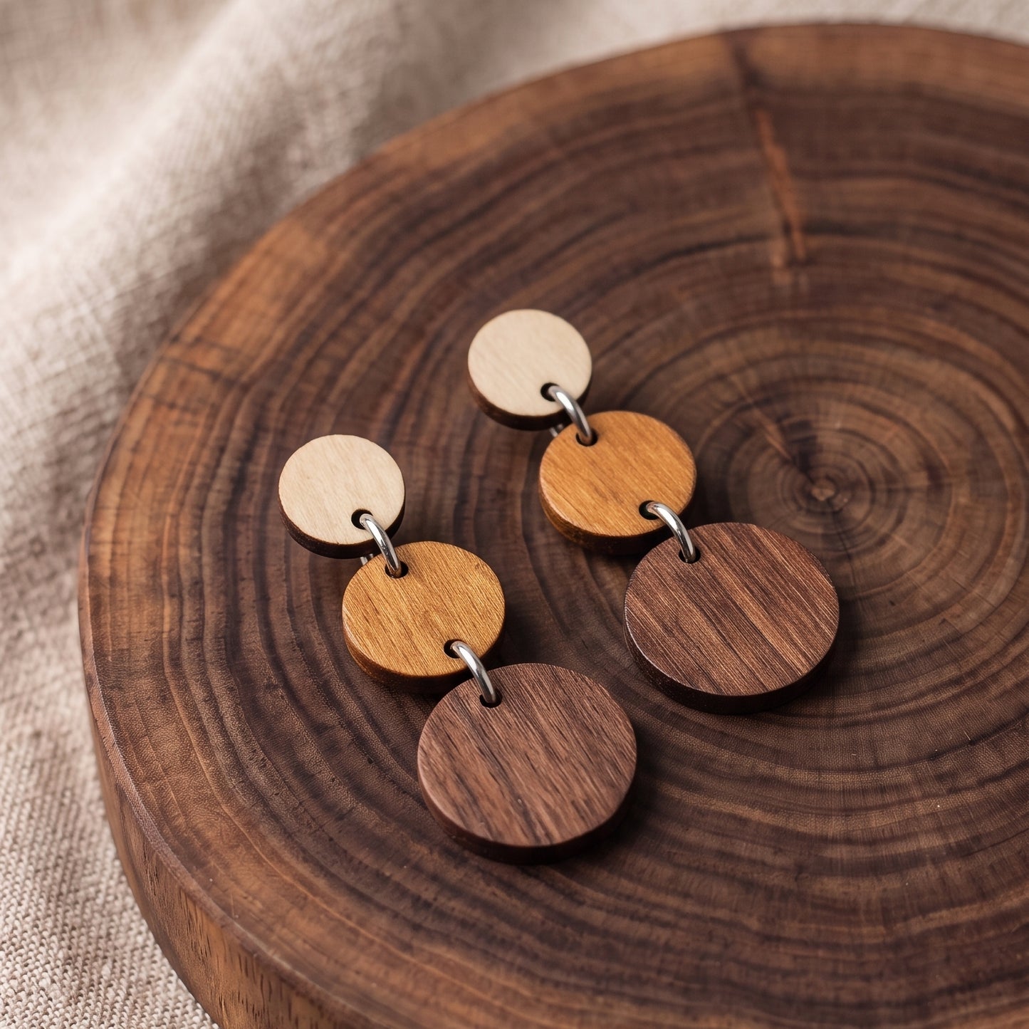 Three-tier ombre wooden circle dangle earrings in natural wood tones, handmade by Mekala Crafts