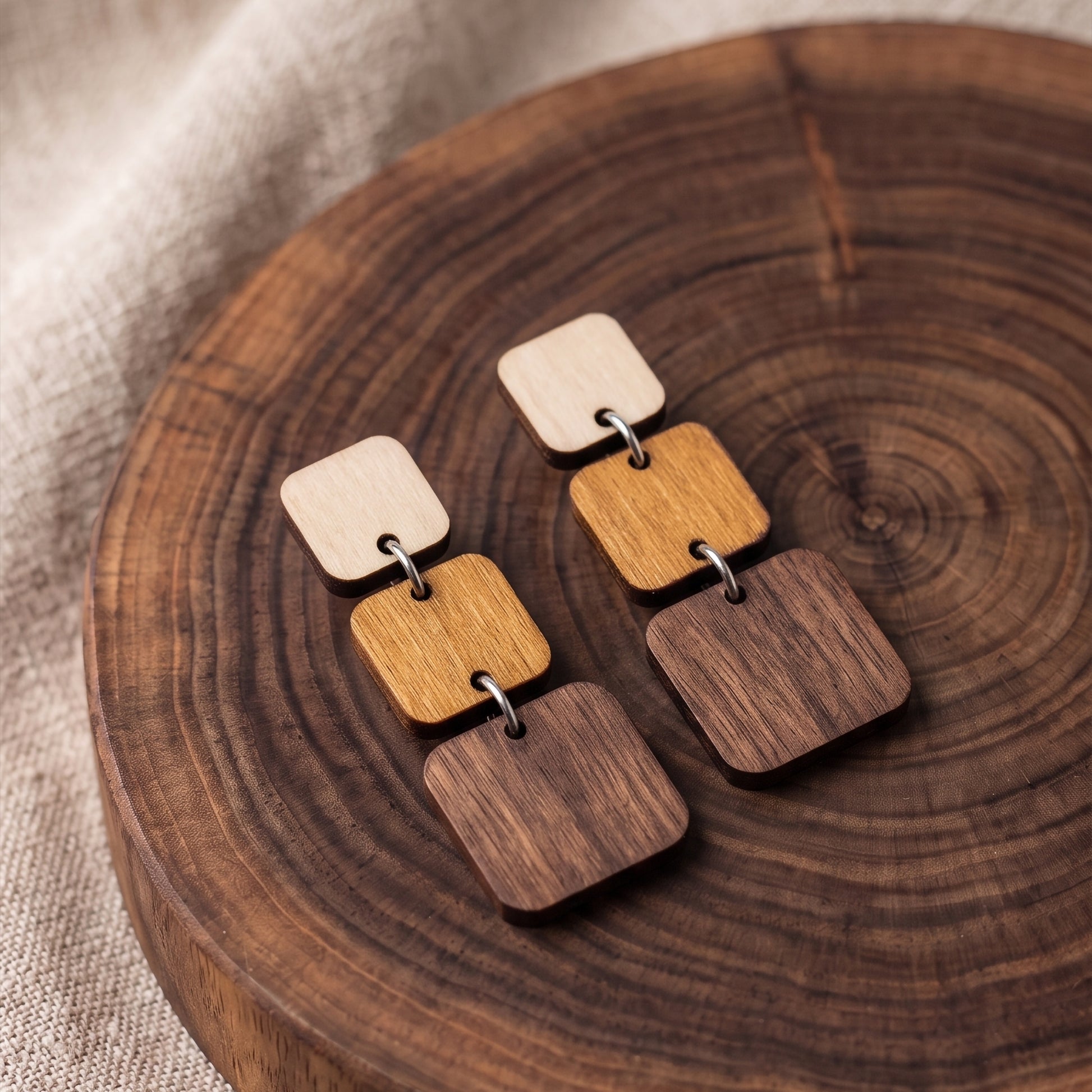 Three-tier ombre wooden square dangle earrings in natural wood tones, handmade by Mekala Crafts