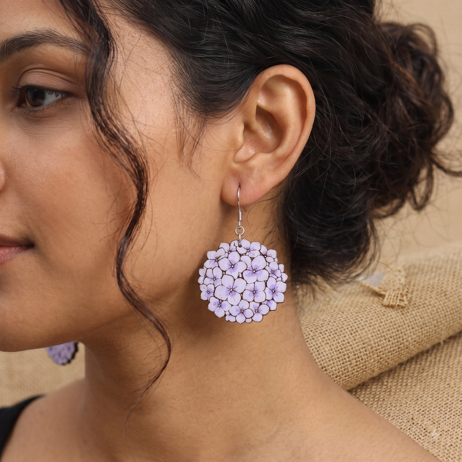 Woman wearing purple hydrangea flower cluster wooden dangle earrings, handmade jewelry by Mekala Crafts