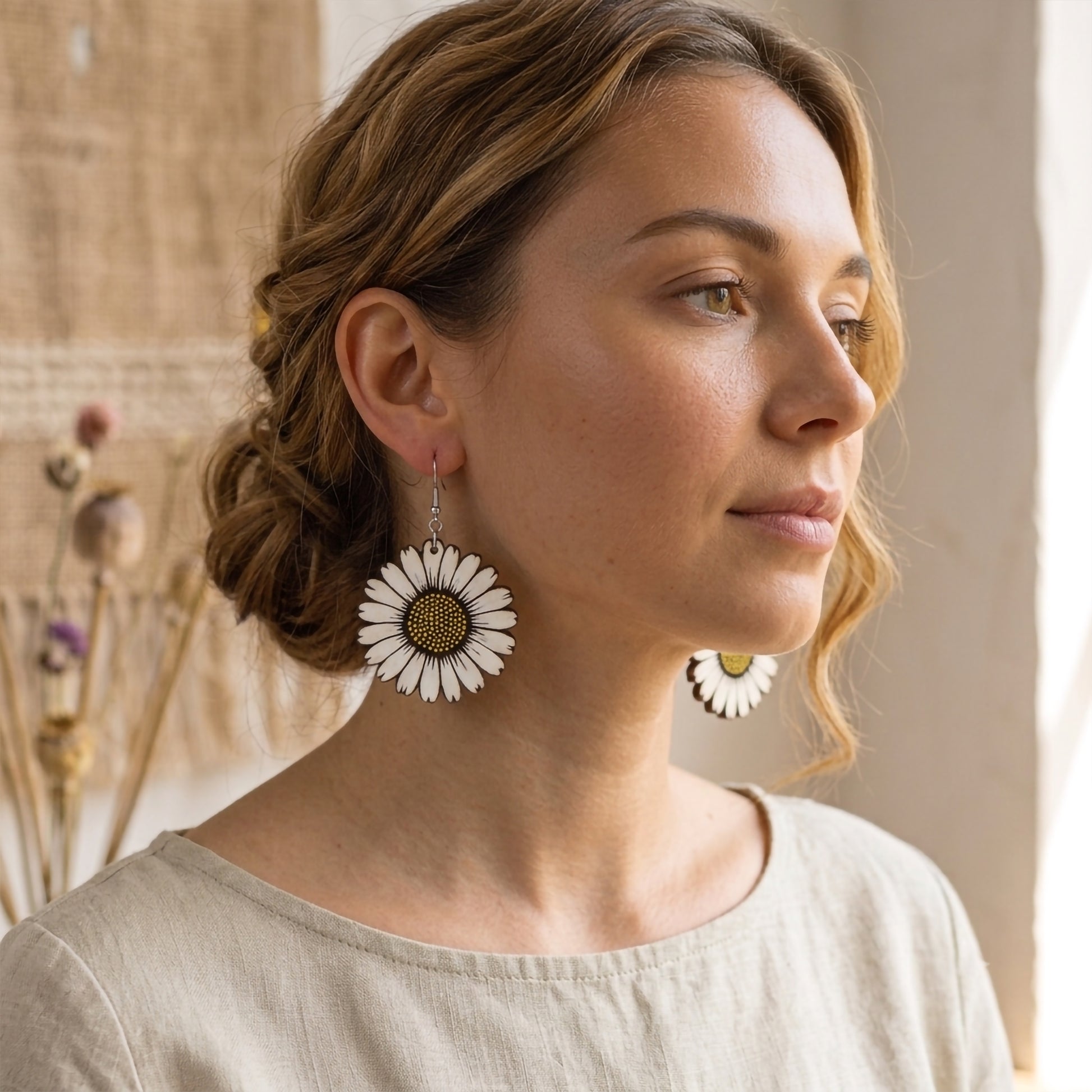 Woman wearing white daisy flower wooden dangle earrings, handmade jewelry by Mekala Crafts