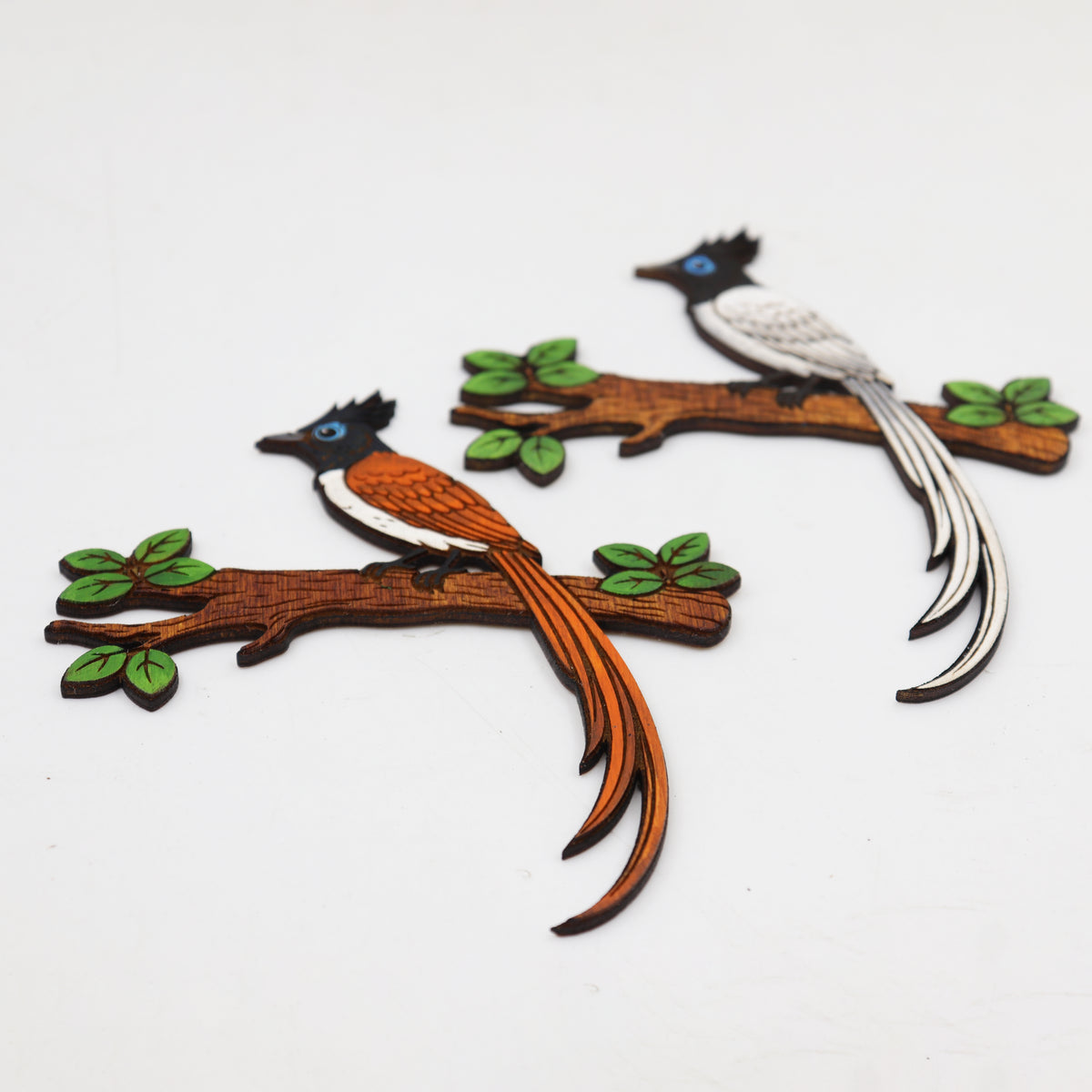 Close-up view of hand-painted wooden bird magnets showing the 3mm wood thickness and detailed acrylic painting