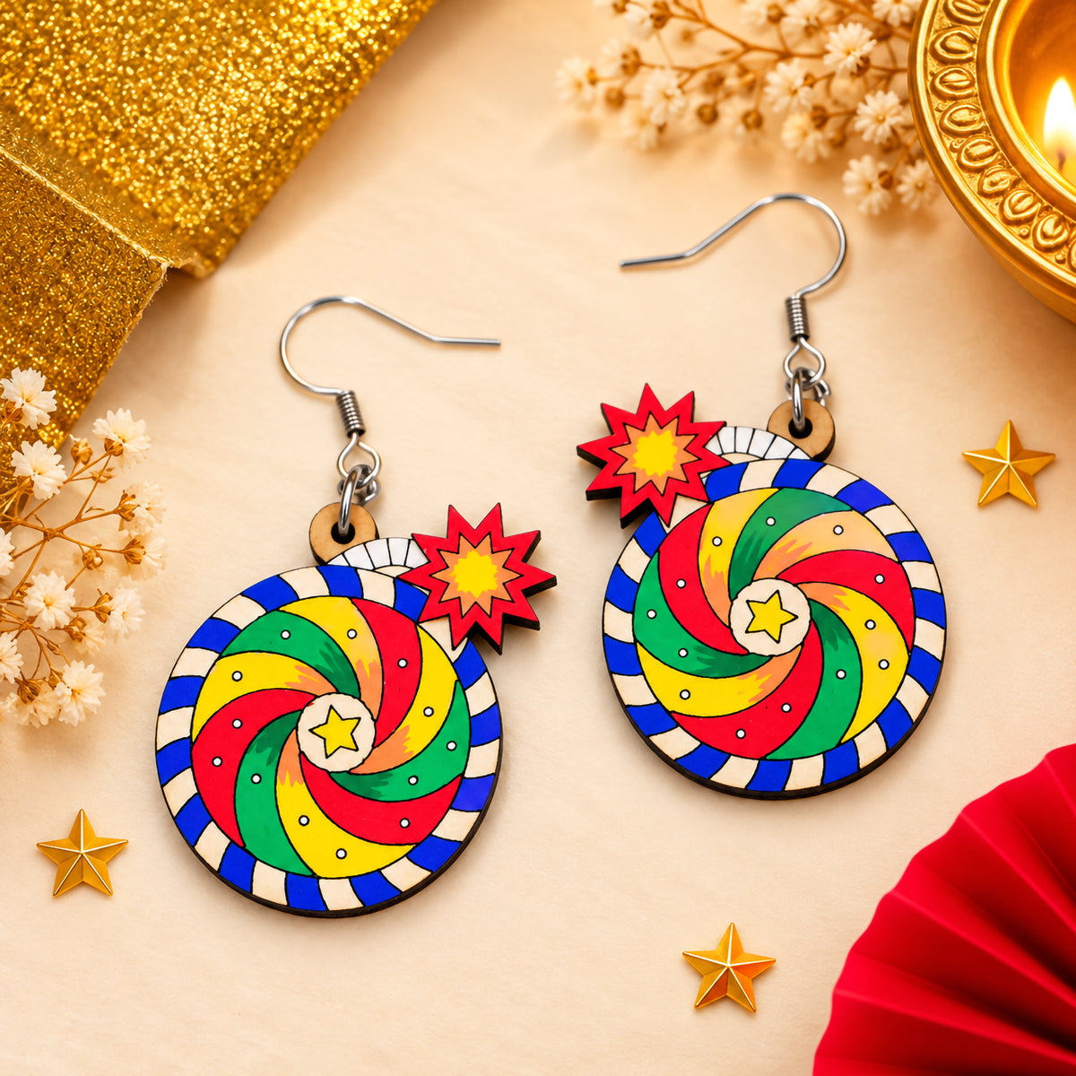 Colorful hand-painted wooden Chakkar cracker earrings with circular red, yellow and green spiral designs, blue borders and starburst accents.