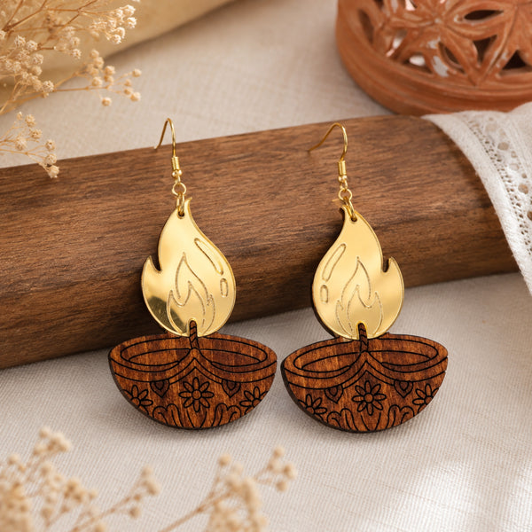 Wooden diya lamp earrings with gold acrylic flame and engraved floral pattern, festive Diwali jewelry by Mekala Crafts